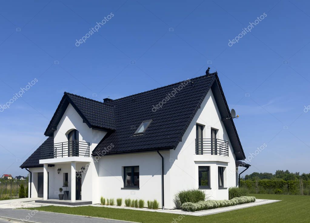 Exterior of a modern white suburban house in Poland. Contemporary architecture abstract.