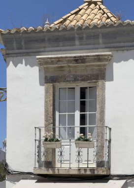 Faro, Portekiz - 24 Haziran 2024: Eski Faro kasabası, balkon pencereli ticari bölge