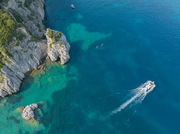 Aerial view of a boat near the coast of the island of Corfu, crystal clear sea. Greece