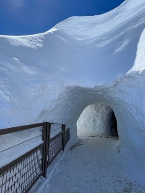 Haute-Savoie, France, 04-25-2024: ice tunnel on the top of LAiguille du Midi (Needle at midday), the highest spire (3.842 m) of the Aiguilles de Chamonix in the northern part of the Mont Blanc massif clipart