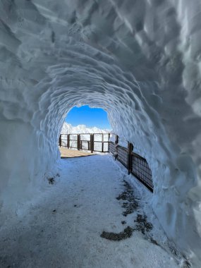 Haute-Savoie, France, 04-25-2024: ice tunnel on the top of LAiguille du Midi (Needle at midday), the highest spire (3.842 m) of the Aiguilles de Chamonix in the northern part of the Mont Blanc massif clipart
