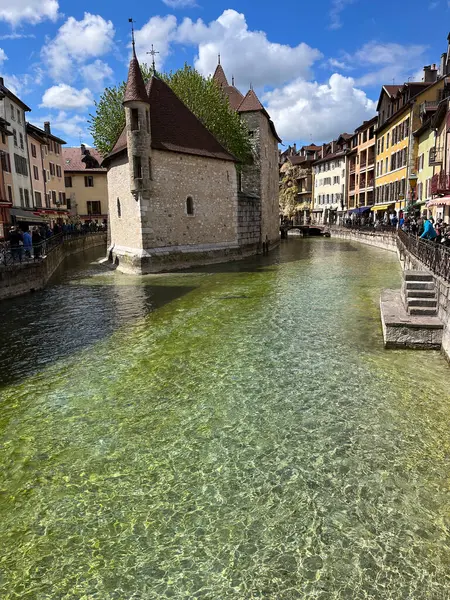 stock image Annecy, Haute-Savoie, France, 04-21-2024: Palais de l'Ile, residence of the castellan of Annecy since12th century, built in the middle of the Thiou River, classified as Historic Monument of France