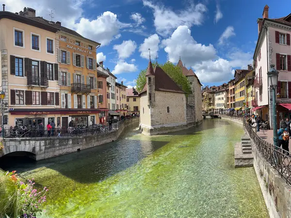 stock image Annecy, Haute-Savoie, France, 04-21-2024: Palais de l'Ile, residence of the castellan of Annecy since12th century, built in the middle of the Thiou River, classified as Historic Monument of France