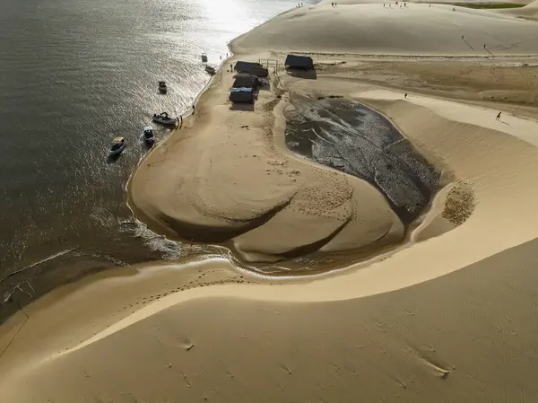 stock image Aerial view of Parque da Dunas - Ilha das Canarias, Brazil. Huts on the Delta do Parnaba and Delta das Americas. Lush nature and sand dunes. Boats on the river bank