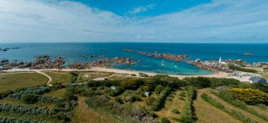 Aerial view of Pontusval Lighthouse and the beaches. Plounour-Brignogan-Plages, France. Rocks singularly shaped. Boats moored in the Atlantic Ocean in front of enormous rock formations. The Coast of Legends clipart