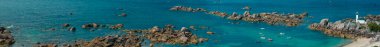 Aerial view of Pontusval Lighthouse and the beaches. Plounour-Brignogan-Plages, France. Rocks singularly shaped. Boats moored in the Atlantic Ocean in front of enormous rock formations. The Coast of Legends clipart