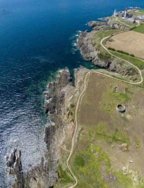 Aerial view of Saint-Mathieu Lighthouse located in Plougonvelin, around Brest in Finistre, and close the ruins of the ancient Abbaye Saint-Mathieu de Fine-Terre. France clipart