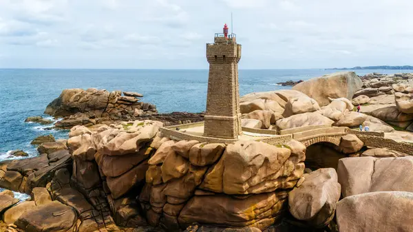 stock image Aerial view of Ploumanac'h Lighthouse, located in Perros-Guirec, France. The structure is composed of pink granite.  Brittany coast, ocean waves crashing on the rocks. Coastal path