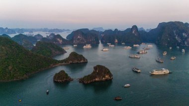 Aerial view of the H Long Bay, Halong Bay is a UNESCO World Heritage Site and popular travel destination in Quang Ninh province, Vietnam. Cruise ships and islands alternate in the bay. Sunset