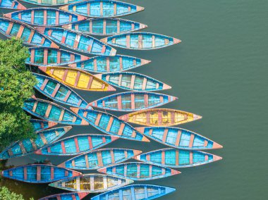 Aerial view of typical Nepalese boats moored along the lake shores of Begnas Lake, Lekhnath, Nepal clipart