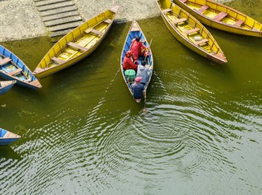 Aerial view of typical Nepalese boats moored along the lake shores of Begnas Lake, Lekhnath, Nepal clipart