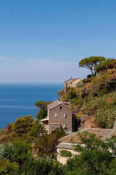 Korsika, Avrupa: Nonza 'nın ufuk çizgisinin panoramik manzarası, Cap Corse' un batı kıyısındaki eski evleri Akdeniz 'e 100 metre uzaklıktaki sarp kayalıklarda tünemiş köy.