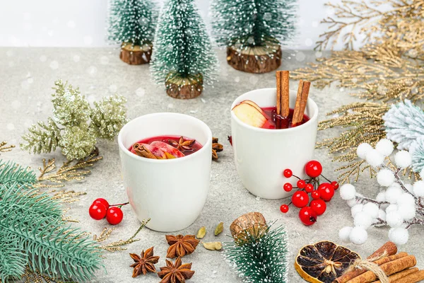 stock image Mulled wine with spices and traditional Christmas decor. Hot beverage, festive stone background, New Year good mood, flat lay