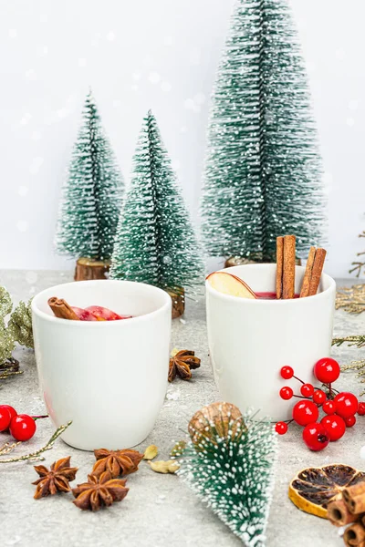 stock image Mulled wine with spices and traditional Christmas decor. Hot beverage, festive stone background, New Year good mood, flat lay