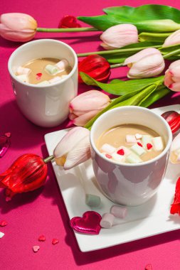 Valentine's Day romantic concept. Coffee with marshmallows, tulips flowers, traditional design. Viva magenta color background, trendy hard light, dark shadow, close up