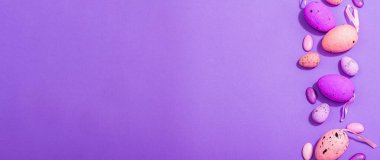 Easter egg composition. A traditional festive symbol in lilac tones. Cute design, hard light, dark shadow, trendy very peri color background, banner format
