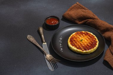 Tabakta ızgara Halloumi peyniri. Çatal bıçak takımı, piknik ya da barbekü için geleneksel yemek. Modaya uygun sert ışık, koyu gölge, düz zemin, siyah taş beton zemin, kopyalama alanı