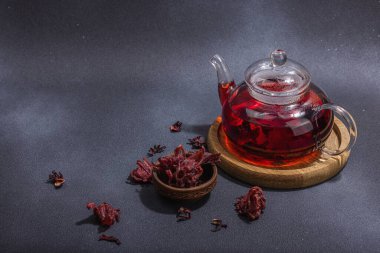 Hibiscus sıcak çay ve hurma. Koyu beton zeminde iftar ya da Suhoor yemeği için geleneksel Ramazan Kareem konsepti. Arap tatlısı, sert ışık, karanlık gölge, kopyalama alanı.