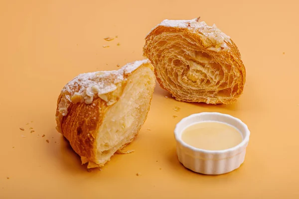 Good morning concept. Fresh croissants with cream filling and almond flakes. Sweet dessert, deconstruction, selective focus, flat lay, close up