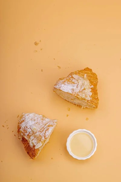 Good morning concept. Fresh croissants with cream filling and almond flakes. Sweet dessert, deconstruction, selective focus, flat lay, top view
