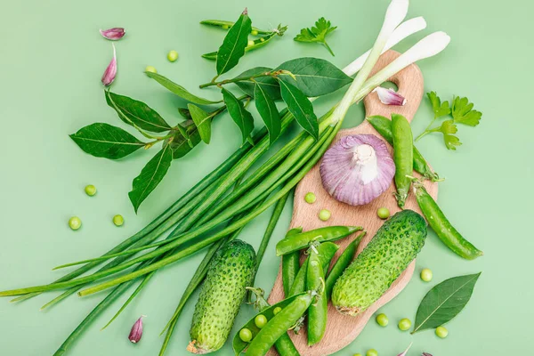 Culinary background in green tones. Preserved and fermented food concept, variety of fresh vegetables and greens. Flat lay, healthy lifestyle, top view