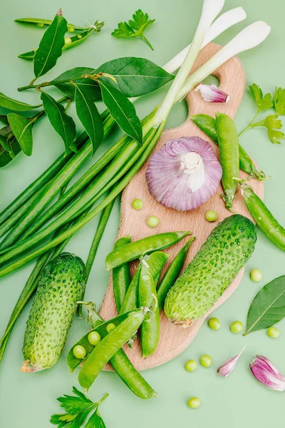 Culinary background in green tones. Preserved and fermented food concept, variety of fresh vegetables and greens. Flat lay, healthy lifestyle, top view