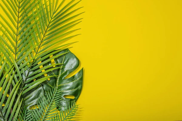 stock image Summer vacation concept. Marine decor, palm and monstera leaves. Bright yellow background, hard light, dark shadow, flat lay, top view