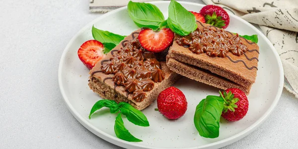 stock image Delicious chocolate cakes with fresh strawberries. Sweet dessert, good morning concept. Homemade baking, cream, topping. Light stone concrete background, banner format