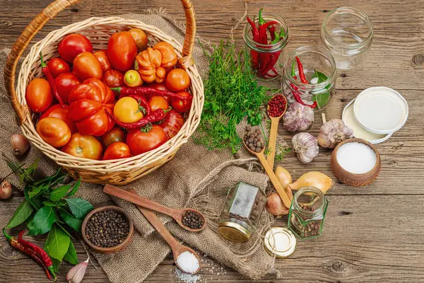 Preserved season vegetable concept. Harvest of tomato, chili, greens, onion and garlic. Ingredients for swicy canned food, cooking process. Healthy recipes, home cuisine, top view