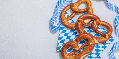 Geleneksel Oktoberfest Krakerleri. Alman festivali yemek konsepti. Modaya uygun sert ışık, koyu gölge, aydınlık taş zemin, afiş biçimi