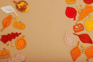 El yapımı sonbahar arkaplanı. Farklı düşme şekilleri, örülmüş yapraklar ve ahşap balkabakları. El işi, hobi konsepti, açık bej arka plan geleneksel dekor, üst görünüm