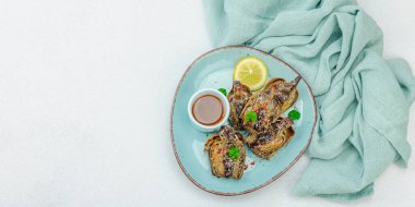 Parmesan peynirli ve soslu lezzetli bir enginar. Zeytinyağı, sarımsak, maydanoz ve limon. Hafif taş arkaplan, vejetaryen yemeği yemeye hazır, afiş formatı