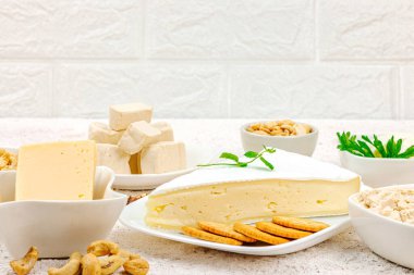 Çeşitli ev yapımı vejetaryen fındık peyniri seti. Tabakta çiğ sağlıklı sos, laktozsuz yemek. Biyolojik organik ürün, bitki temelli diyet, alternatif yaşam tarzı. Işık taşı arkaplanı, boşluğu kopyala