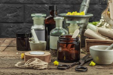 Verbascum çiçekleri, bitkisel kavanozlar, antika aletler ve ahşap masada havan topuyla kırsal eczacılık sahnesi. Alternatif tıp, sağlıklı yaşam tarzı konsepti, kopyalama alanı