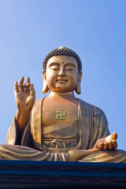 Kaohsiung, Tayvan 'daki Fo Guang Shan Buda Müzesi' nde mavi gökyüzü arka planlı dev Buda heykelinin yakın çekimi..