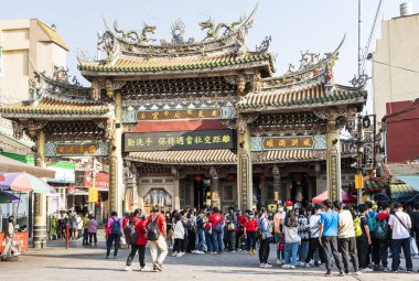 Changhua, Taiwan- December 10, 2021: Tourists are visiting the Lukang Tianhou Temple in Changhua, Taiwan. It is one of the most famous and popular Mazu temples in Taiwan. clipart