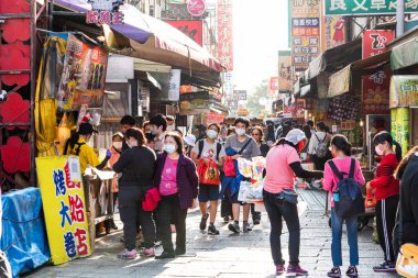 Changhua, Tayvan- 10 Aralık 2021: Turistler Changhua, Tayvan 'daki Lukang eski caddesini ziyaret ediyorlar. Qing Hanedanlığı 'nın mimari özellikleri burada korunmuş..