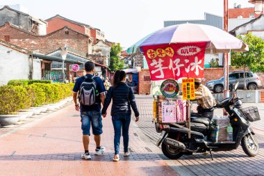 Changhua, Taiwan- December 10, 2021: Tourists visit Lukang old street in Changhua, Taiwan. The architectural features of the Qing Dynasty are preserved here. clipart