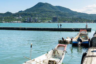 New Taipei City, Taiwan- August 28, 2021: View of the First Tamsui Fishing Harbor in New Taipei City, Taiwan. It's one of the attractions in the Guanyinshan National Scenic Area on the north coast. clipart