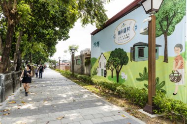 Pingtung, Taiwan- April 29, 2022: Tourists visit the Duxingshi Village Cultural Park in Penghu, Taiwan. which used to be a military dependents' village, is now a cultural and creative park. clipart