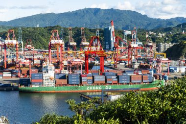 Keelung City, Taiwan- August 14, 2022: The container ship docked at the port of Keelung, Taiwan for loading. clipart