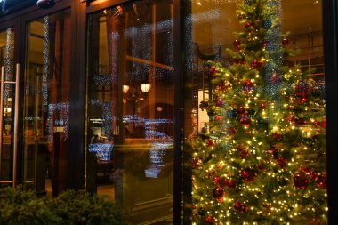 Odaklanamayan ofis, otel lobisi ya da kapalı arka plandaki alışveriş merkezi. Noel ışığı ağaçta parlıyor.