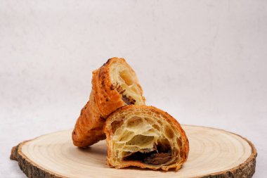 Croissant, Food, Bakery, Baking background. French breakfast. Homemade Sweet dessert with chocolate filling laying on the wood