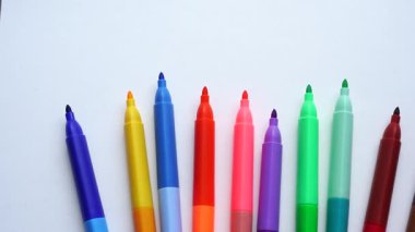 Renkli keçeli kalemler beyaz arkaplanda yarı daire şeklinde dizilir.