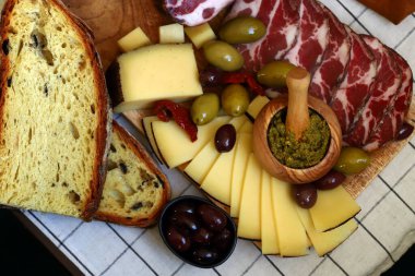Italian board. Cheese, olives, prosciutto, pesto.