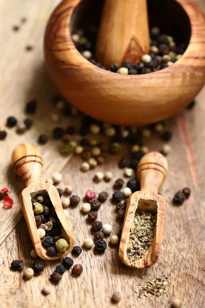 stock image Close-up. Mix of peppercorns in a wooden bowl and in wooden spatulas.