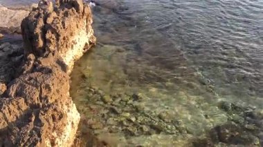 Güzel, sakin bir kıyı manzarası şaşırtıcı derecede berrak sulara büyüleyici kayalara ve canlı su altı yaşamına sahiptir.