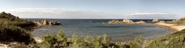 Panoramic view of Cala Rossa, a beautiful beach in Sardinia, Italy.