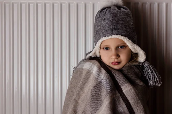 Shutdown of Heating and Electricity, power outage, Blackout. Disconnecting Electric Heat. Unhappy Sad Child Suffering from Cold, experiencing Power Blackout because Energy crisis in Europe.