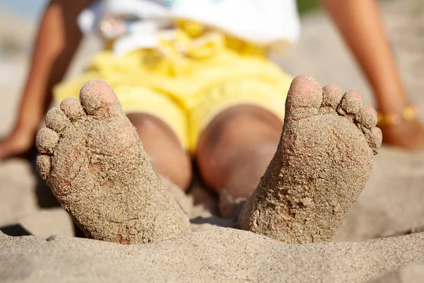 Barefoot Child Bare Feet with Sand on Sea Beach. Sandy Beach is Good for Children Feet. Sea Children Holiday concept.